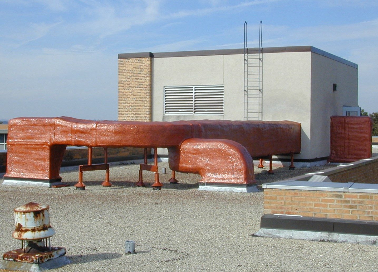 Applicator spraying waterproof membrane on an RV roof